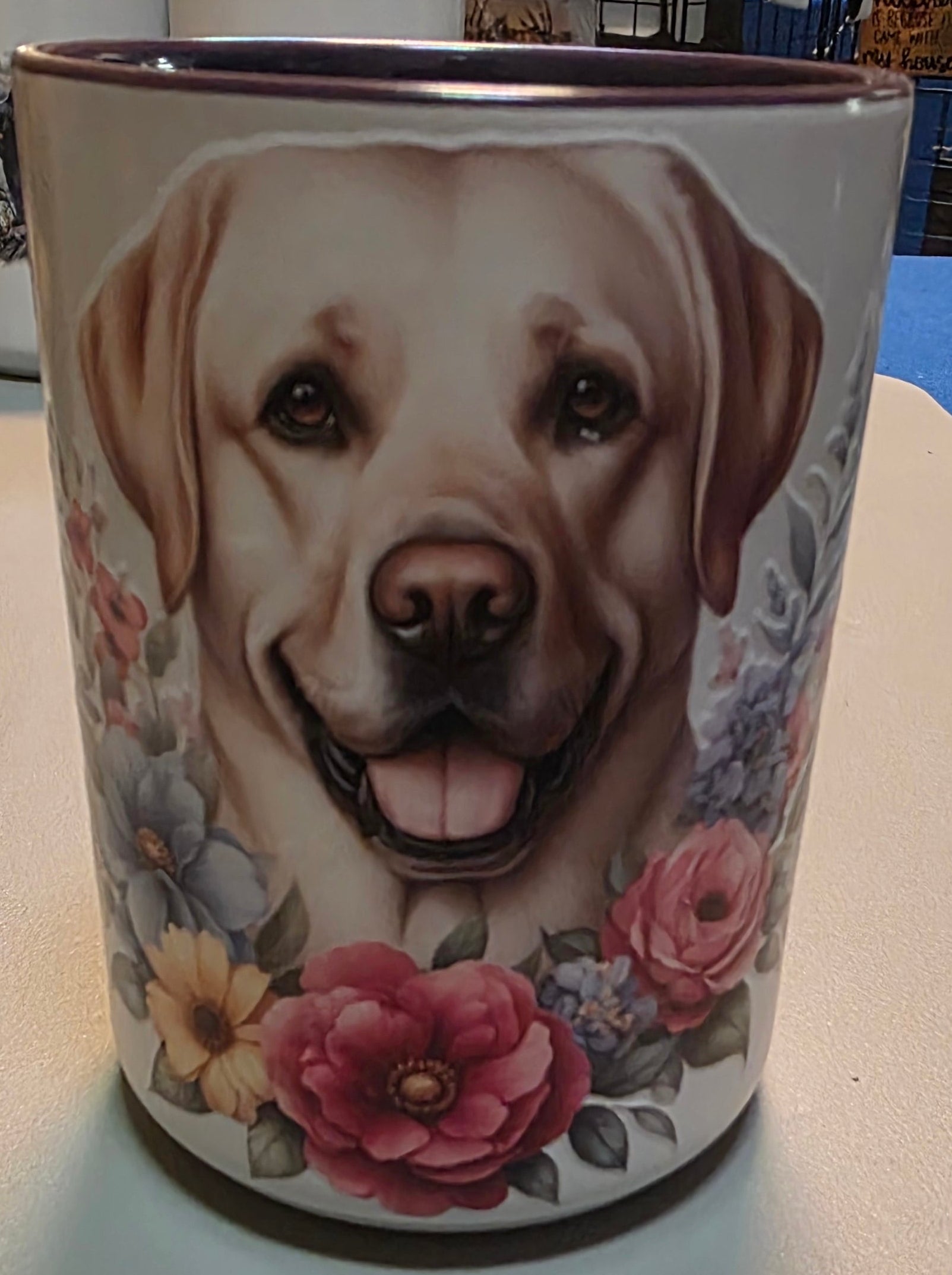 Mug with a dog's face and floral design on a white surface