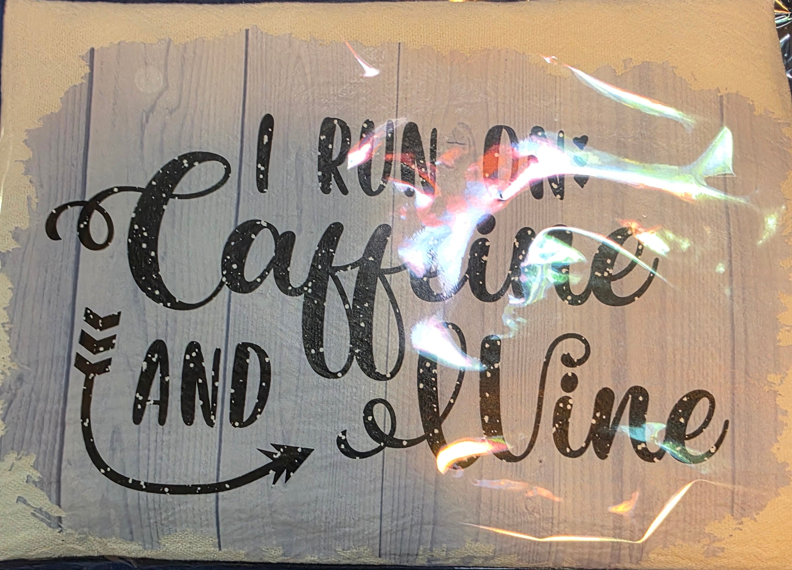 Dish Towel with text 'I run on Coffee and Wine' on a textured surface.
