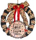 Decorative wreath with a red ribbon and 'True Love Has Four Paws' text on a white background