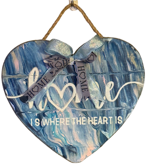Heart-shaped wooden plaque with blue marbled design and text on a white background