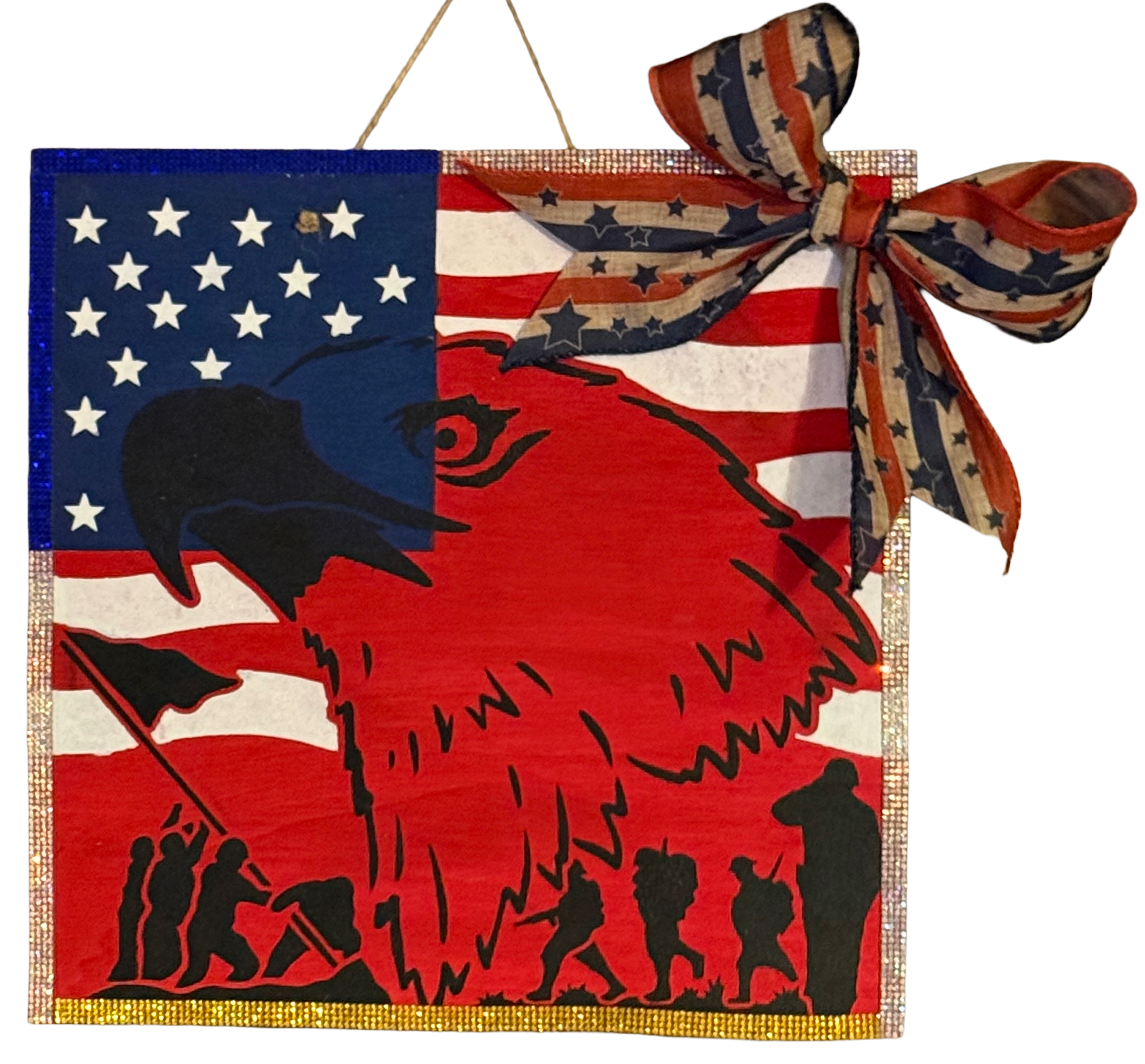 Decorative wall hanging with American flag design and eagle silhouette, featuring a bow on a white background.