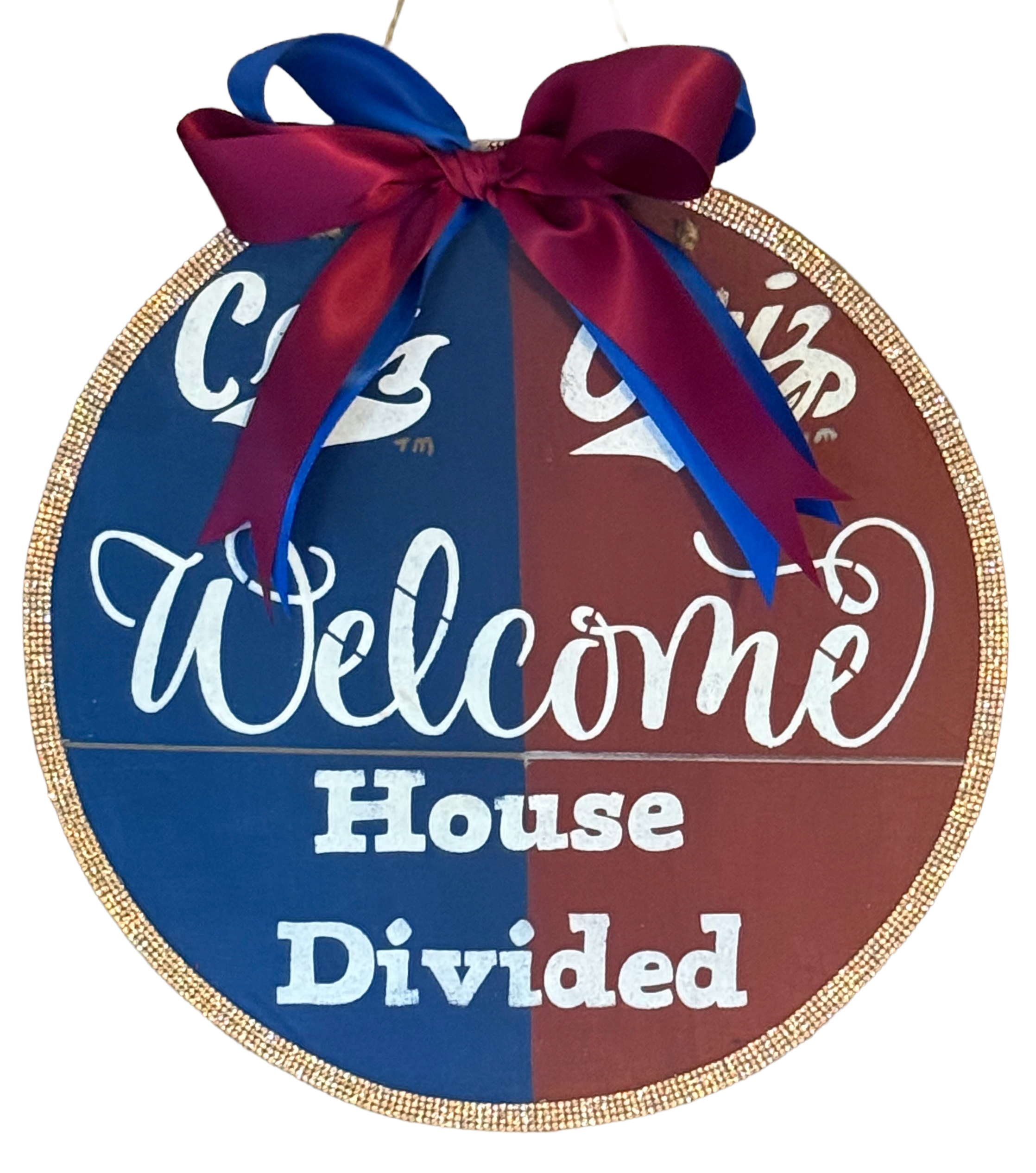 Round decorative sign with 'Welcome House Divided' text and a bow on a white background