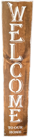 Wooden sign with 'Welcome to our home' text in white letters
