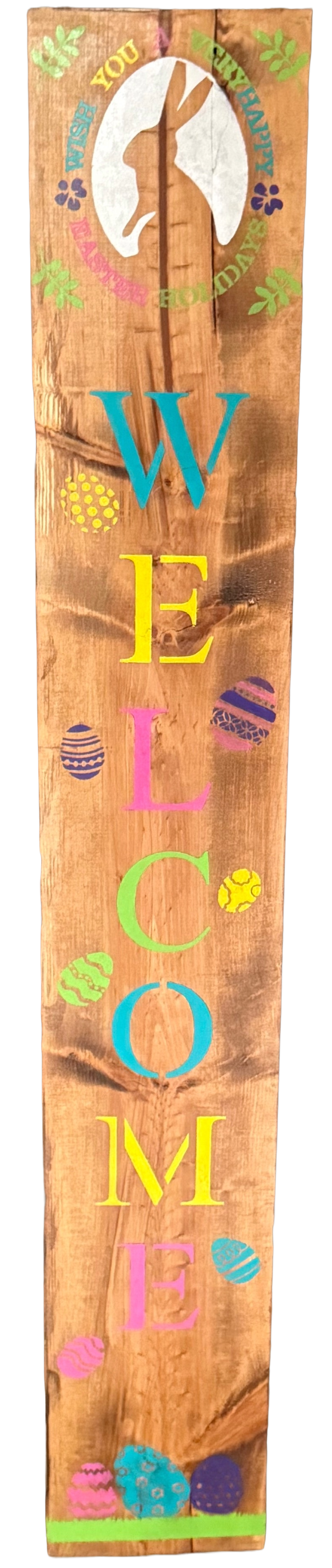 Wooden sign with colorful 'Welcome' text and decorative elements on a wooden background