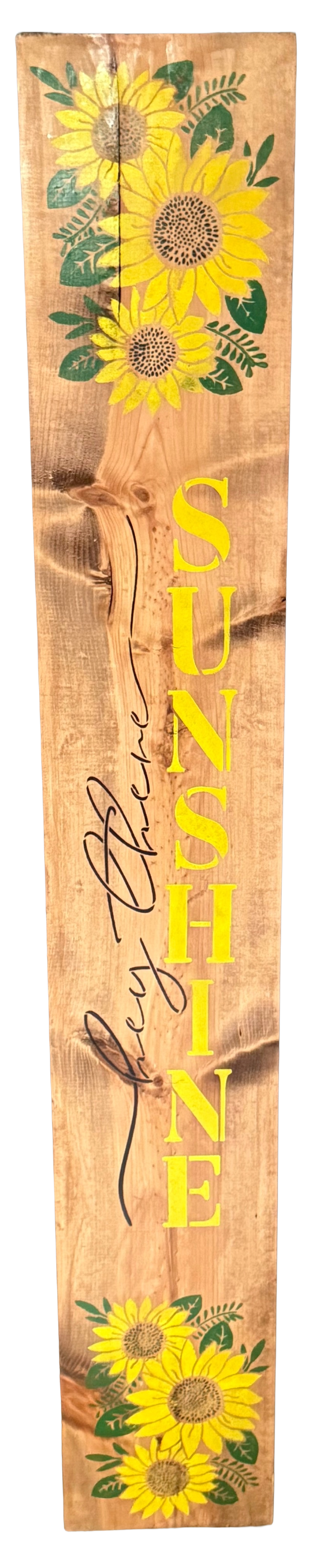 Wooden sign with sunflower designs and the word 'SUNSHINE' on a wooden background