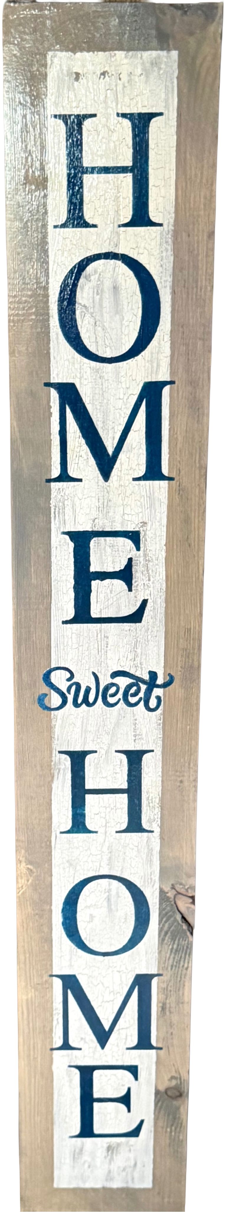 Wooden sign with 'HOME Sweet HOME' text in blue and white on a wooden background