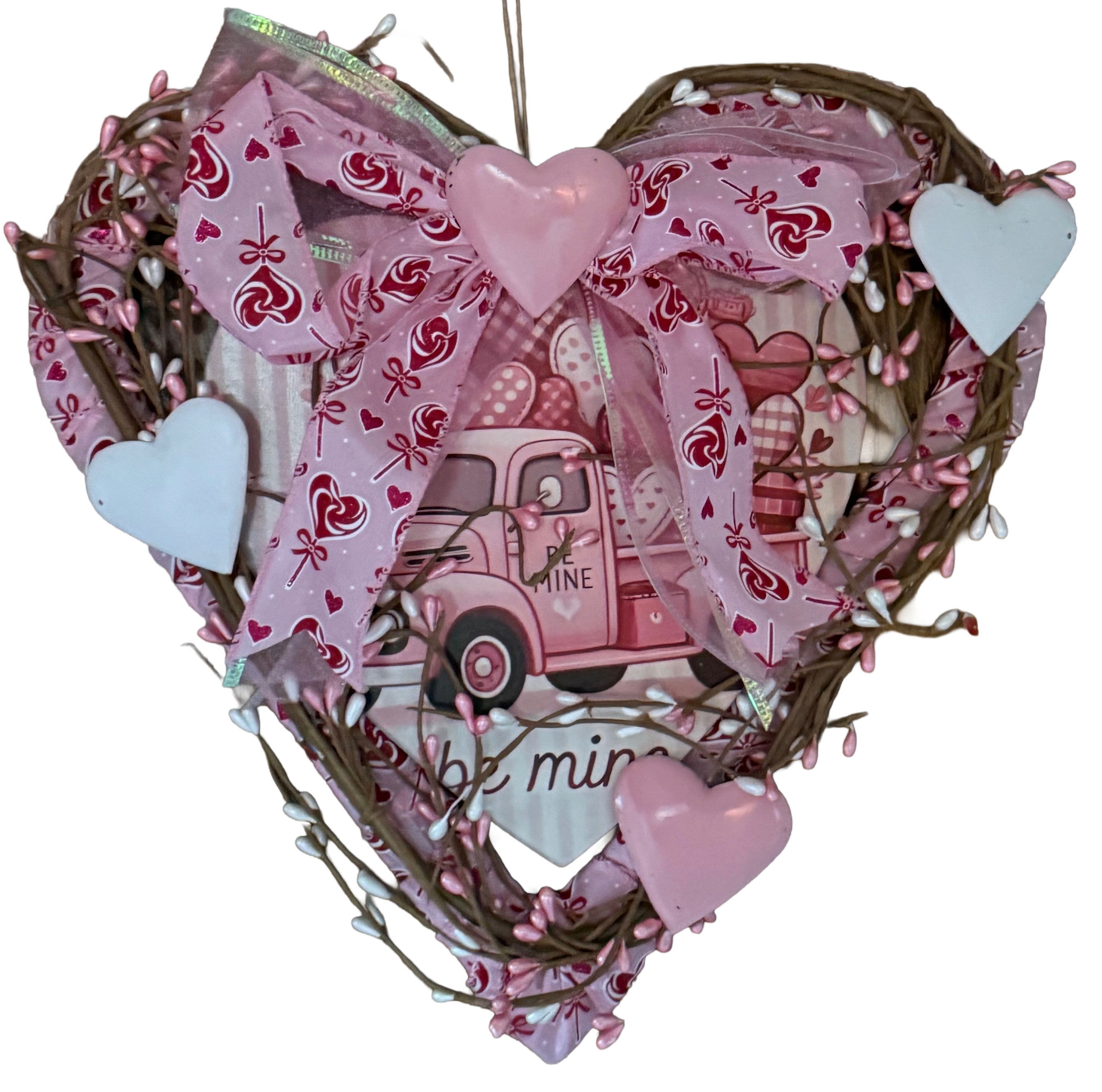 Heart-shaped decorative wreath with pink truck and hearts on a white background