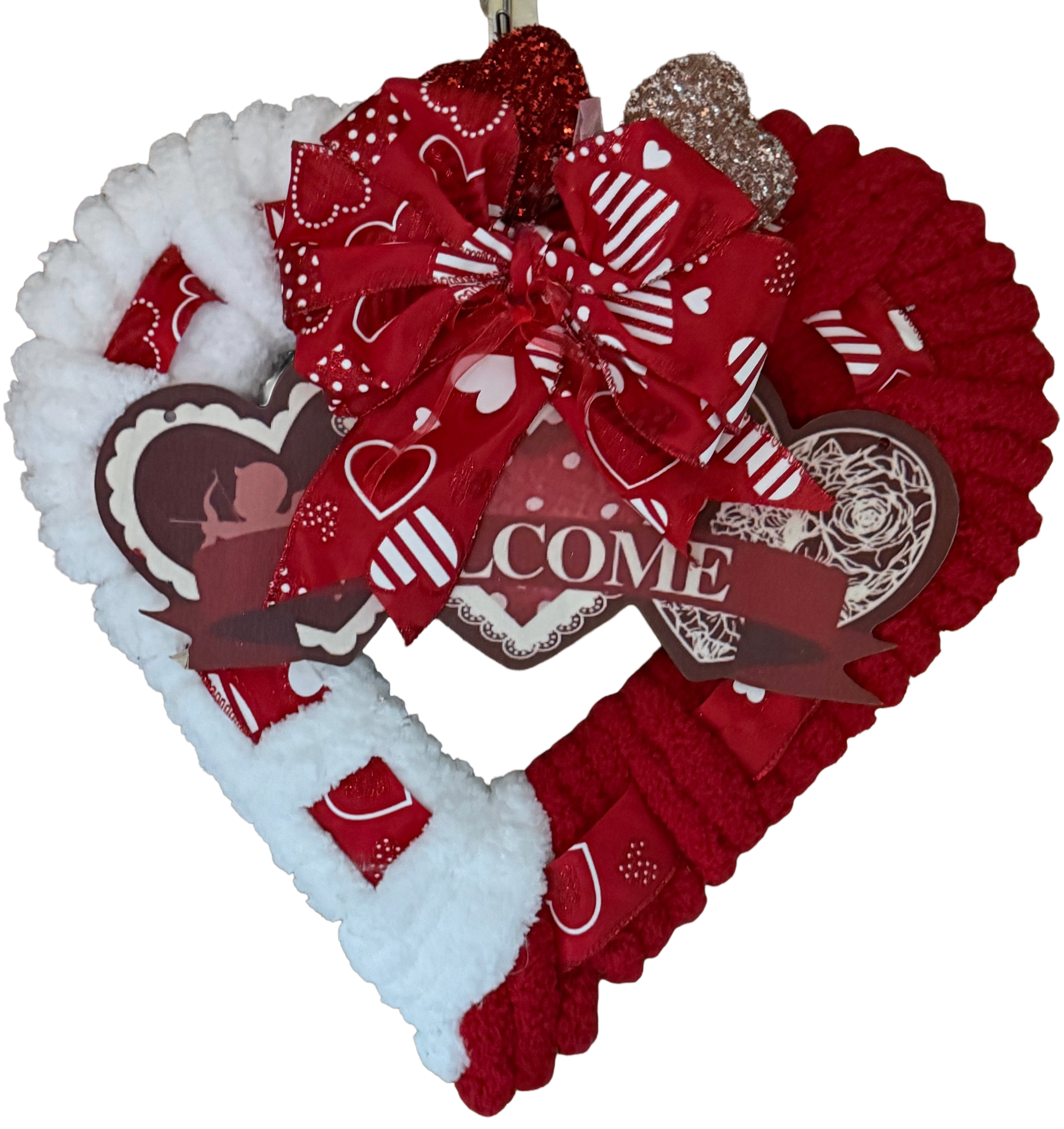 Heart-shaped wreath with red and white decorations on a red and white background.