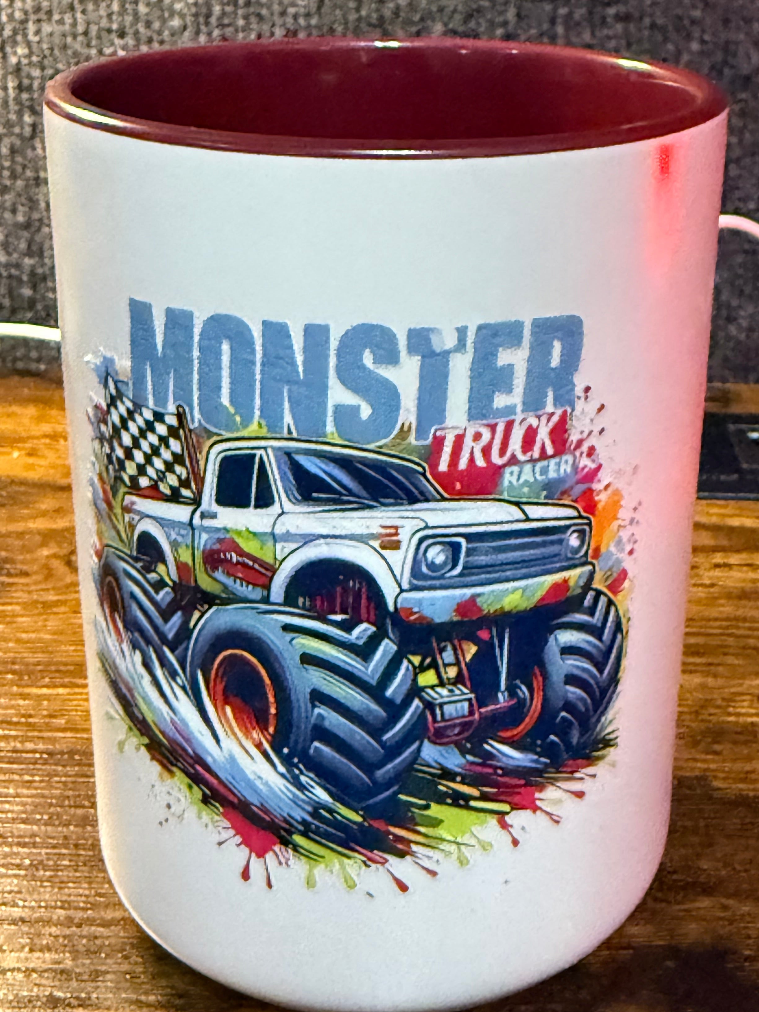 Mug with monster truck design on a wooden surface