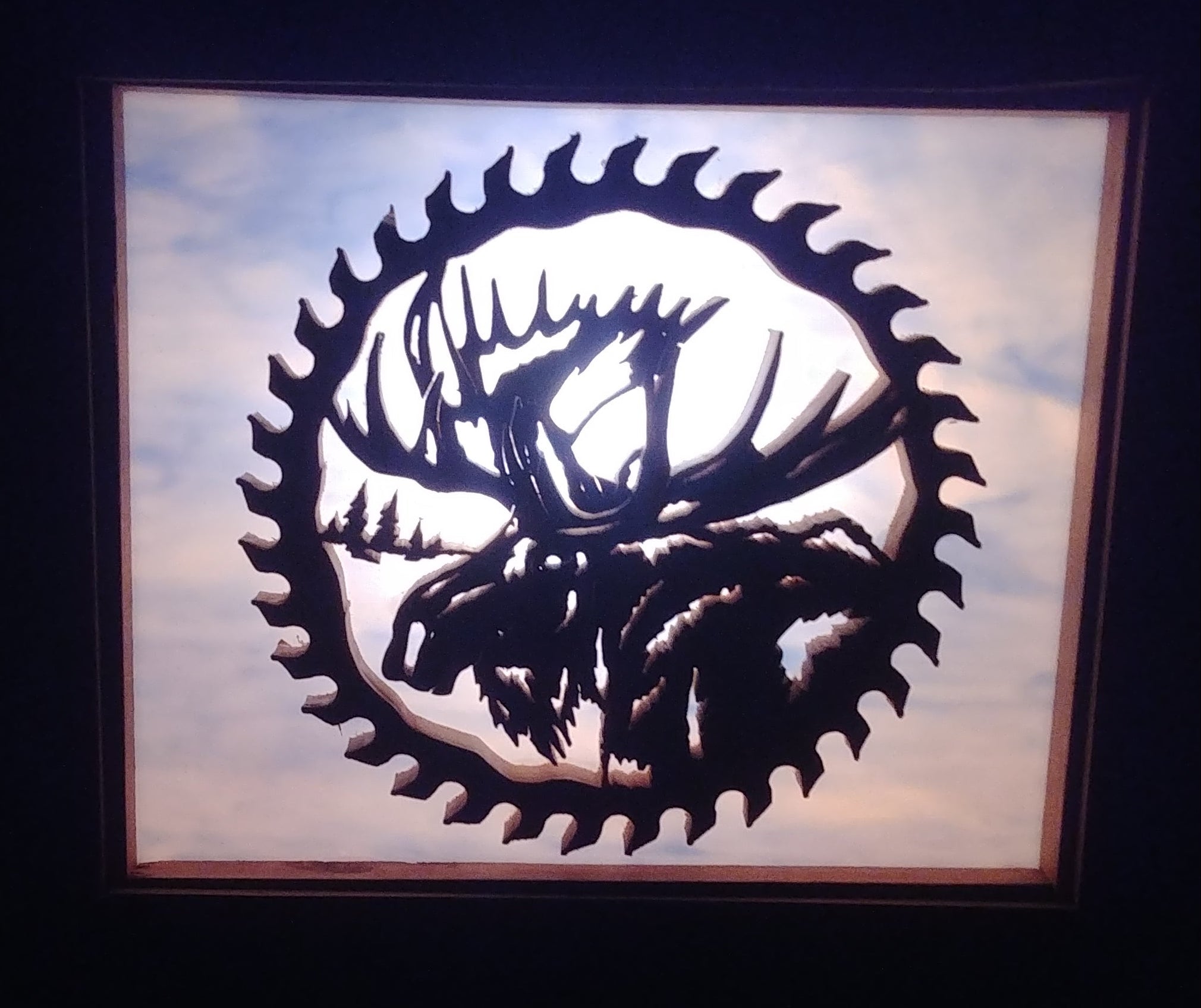 Lighted Shadow Box with scroll saw carving of a Moose in a gear done by hand with a rustic wooden frame.