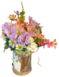 Colorful flower arrangement in a decorative vase on a white background