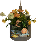 Hanging planter with flowers and a scenic design on a white background