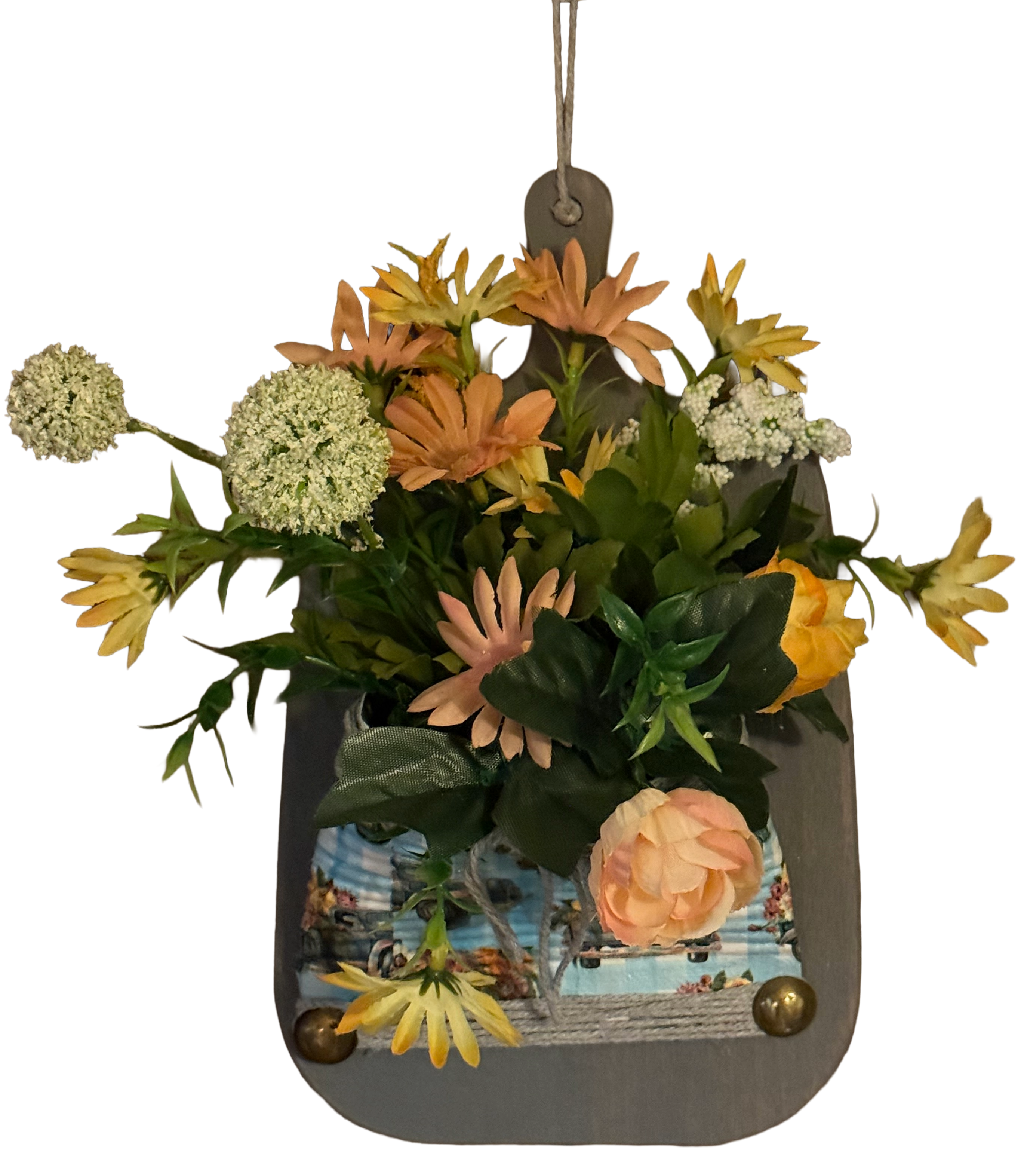 Hanging planter with flowers and a scenic design on a white background