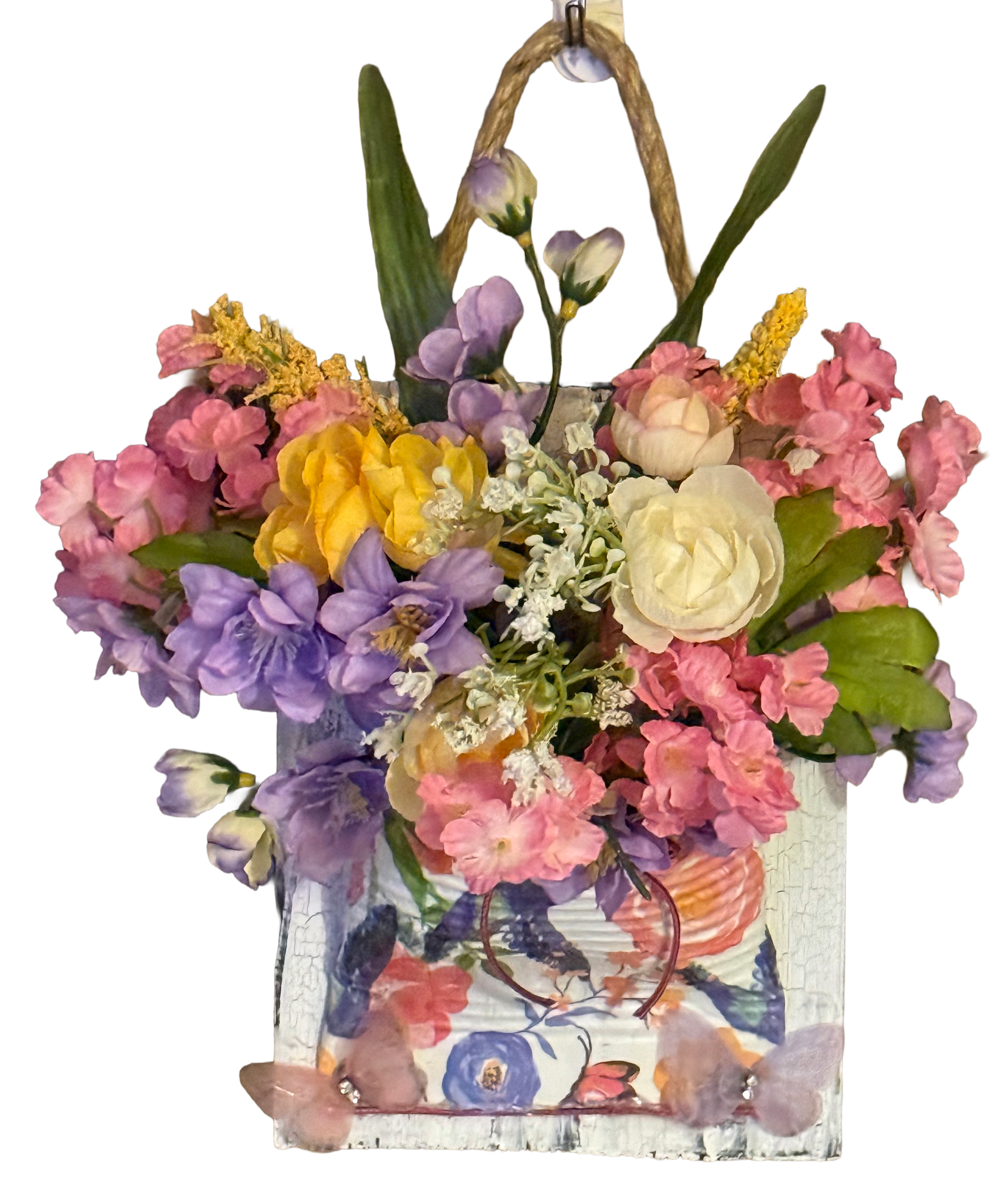 Decorative floral arrangement in a woven basket on a white background