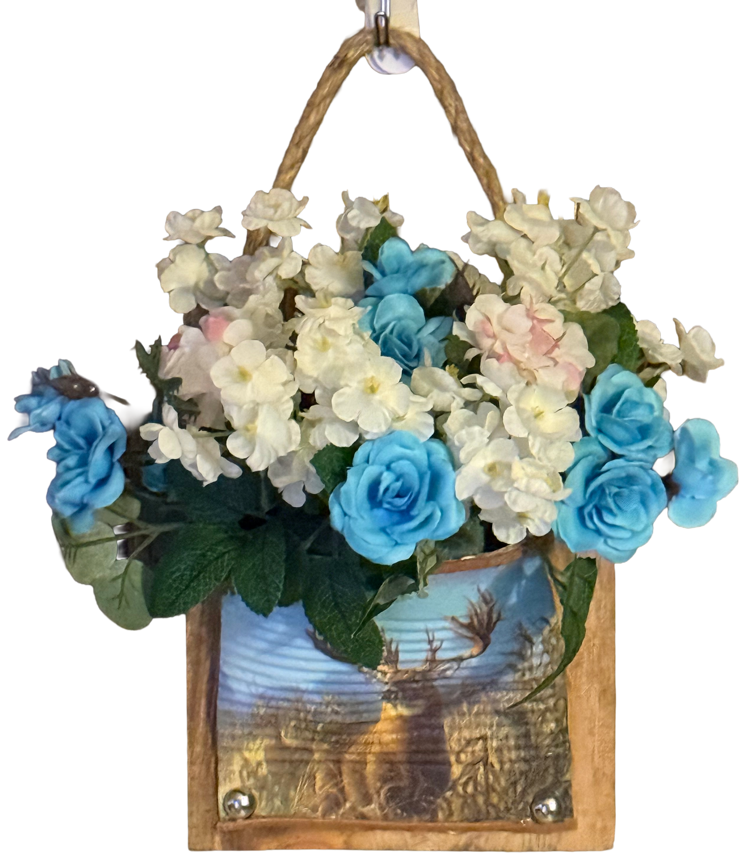 Decorative wall hanging with blue and white flowers and a scenic background.