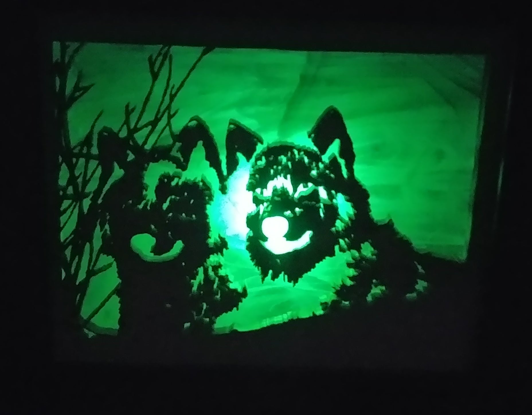 Lighted Shadow Box with scroll saw carving of a pair of wolves done by hand with a rustic wooden frame.