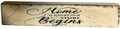 Wooden sign with 'Home is where our story begins' text on a white background